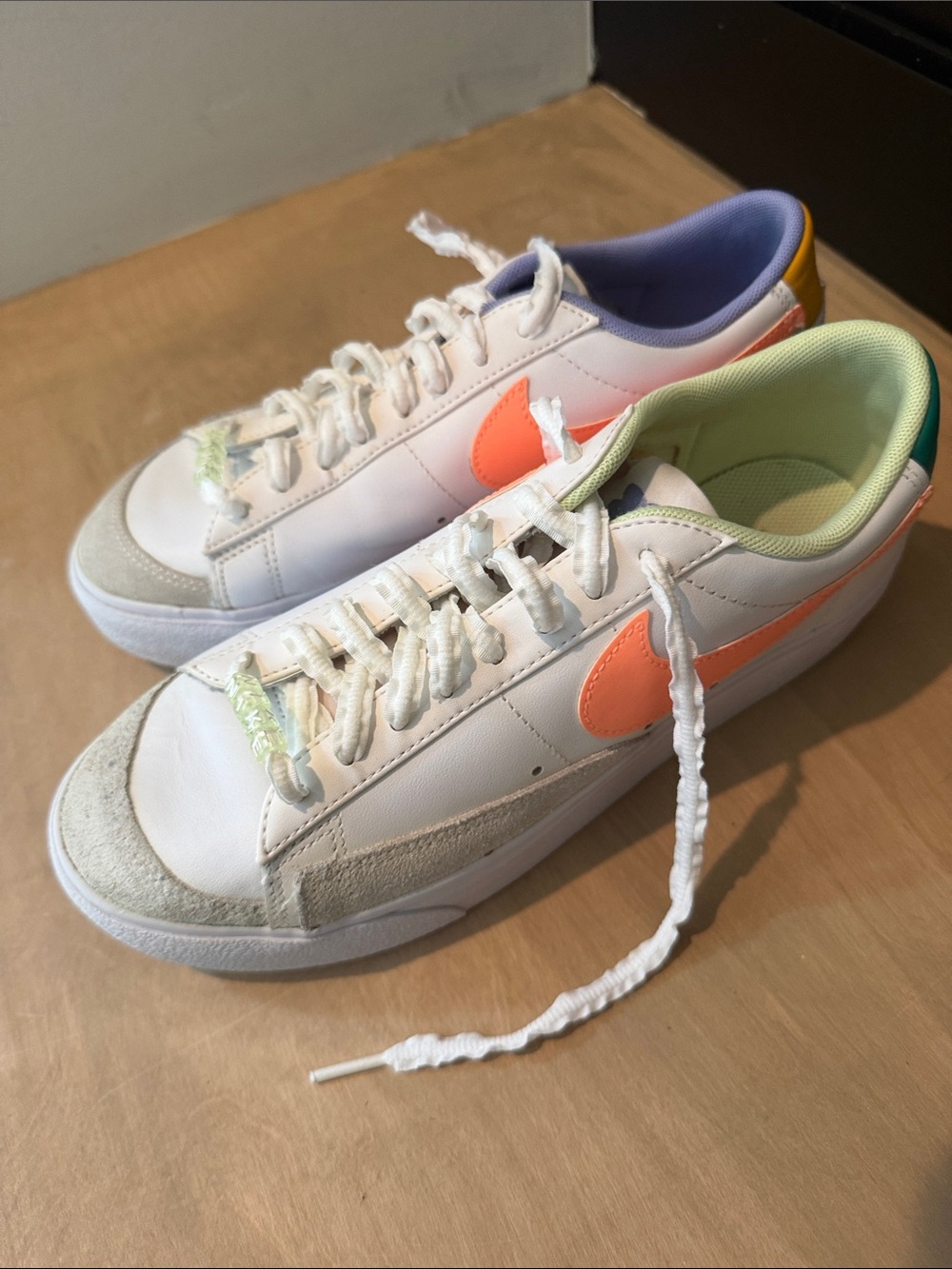 Nike Women’s White Sneakers with Coral Swoosh and Pastel Accents